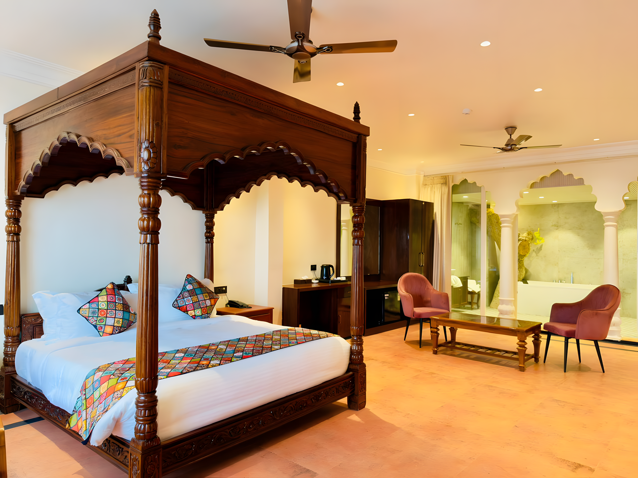 Ganga Darshan Suite four-poster bed at Maharana Mahal Varanasi — deep carved Rajput arch canopy in dark teak, white linen, Banarasi patchwork pillows, Ganga colonnade view — luxury heritage hotel India